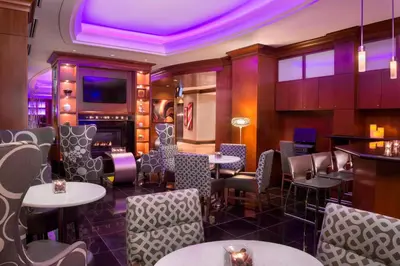 a restaurant with tables and chairs and purple lighting at Residence Inn by Marriott Toronto Downtown / Entertainment District in Toronto