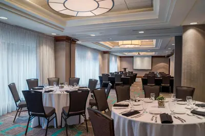 a conference room with tables and chairs and a podium at Residence Inn by Marriott Toronto Downtown / Entertainment District in Toronto