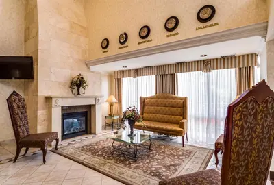 a living room with a couch and a fireplace at Monte Carlo Inn Markham in Markham