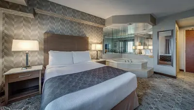 a hotel room with a bed and a bath tub at Monte Carlo Inn Markham in Markham