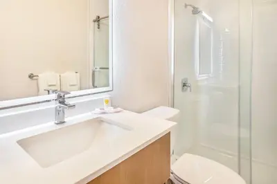 a white bathroom with a sink and a shower at Comfort Inn in London