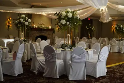 a banquet hall with white tables and chairs and flowers at Best Western Plus Stoneridge Inn & Conference Centre London Ontario in London