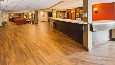 a lobby of a hospital with a wooden floor at Best Western Plus Stoneridge Inn & Conference Centre London Ontario in London