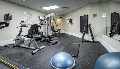 a gym with weights and exercise equipment in a room at Monte Carlo Inn Vaughan Suites in Vaughan
