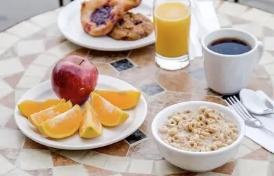 a table with plates of breakfast foods and a cup of coffee at Monte Carlo Inn Vaughan Suites in Vaughan