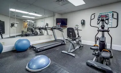 a gym with cardio machines and a mirror at Monte Carlo Inn Vaughan Suites in Vaughan