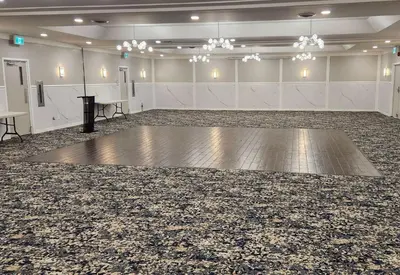 a large room with a dance floor and a stage at Ramada by Wyndham London in London