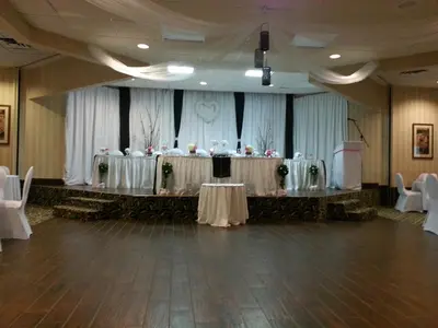 a banquet hall with a table and chairs in a room at Ramada by Wyndham London in London