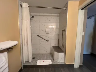a bathroom with a shower with a glass door at Ramada by Wyndham London in London