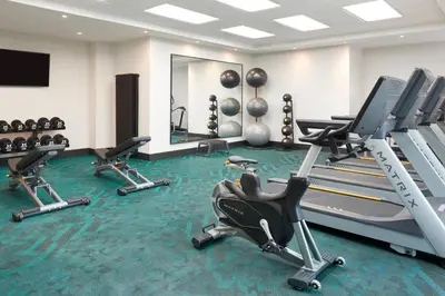 a gym with several treadmills and exercise bikes at TownePlace Suites by Marriott Toronto Oakville in Oakville
