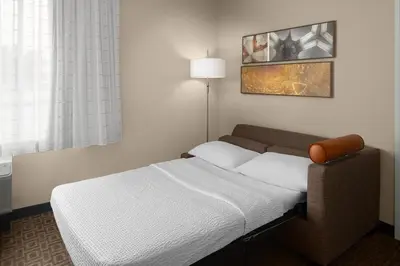 a bedroom with a bed and a lamp in it at TownePlace Suites by Marriott Toronto Oakville in Oakville