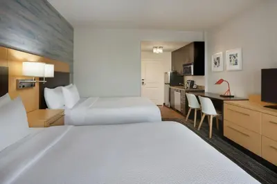 a hotel room with two beds and a kitchen at TownePlace Suites by Marriott London in London