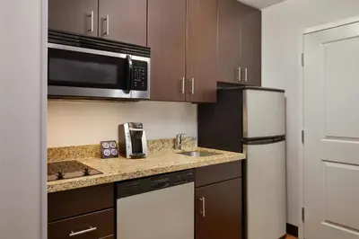 a kitchen with a sink and a refrigerator at TownePlace Suites by Marriott London in London