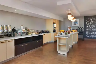 a restaurant with a counter and aasteryasteryasteryasteryasteryasteryasteryasteryastery at TownePlace Suites by Marriott London in London