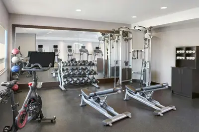 a gym with several exercise bikes and a mirror at TownePlace Suites by Marriott London in London