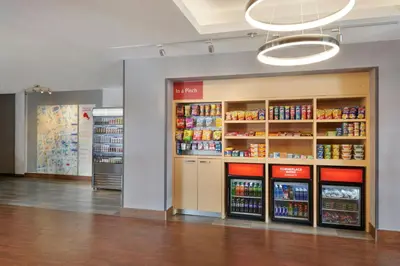 a store aisle with shelves of food and drinks at TownePlace Suites by Marriott London in London