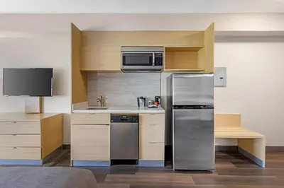 a kitchen with a stainless steel refrigerator and a microwave at Quality Inn & Suites Oakville-Mississauga in Oakville
