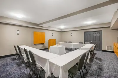 a conference room with white tables and chairs at Quality Inn & Suites Oakville-Mississauga in Oakville