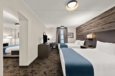 a hotel room with two beds and a television at Best Western Parkway Hotel Toronto North in Richmond Hill