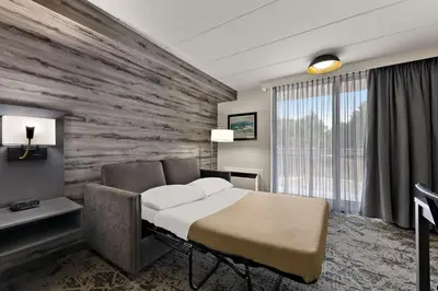 a hotel room with a bed and a stone wall at Best Western Parkway Hotel Toronto North in Richmond Hill