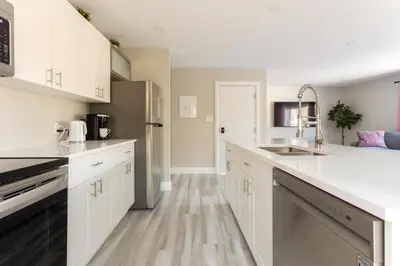a kitchen with white cabinets and a sink at ENTIRE 2 BEDROOM APARTMENT DOWNTOWN - u2 in Kitchener