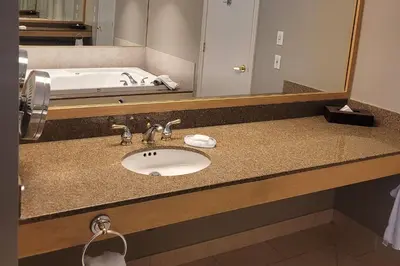 a bathroom counter with a sink and a bath tub at Carriage Ridge Resort, an Ascend Collection Resort in Oro-Medonte