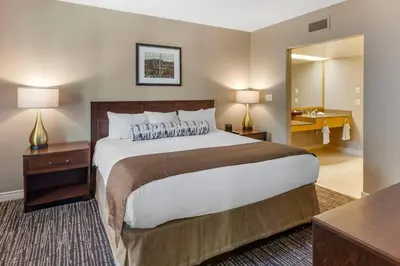 a bedroom with a large bed and a bathroom at Carriage Ridge Resort, an Ascend Collection Resort in Oro-Medonte