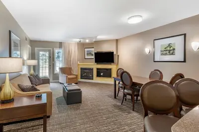 a living room with a couch and a dining room at Carriage Ridge Resort, an Ascend Collection Resort in Oro-Medonte