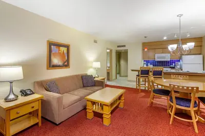 a living room with a couch and a kitchen at Carriage Ridge Resort, an Ascend Collection Resort in Oro-Medonte