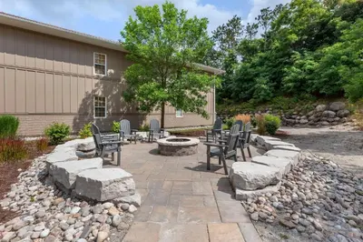a patio with chairs and a fire pit in a yard at Carriage Ridge Resort, an Ascend Collection Resort in Oro-Medonte