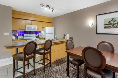 a kitchen and dining room with a table and chairs at Carriage Ridge Resort, an Ascend Collection Resort in Oro-Medonte