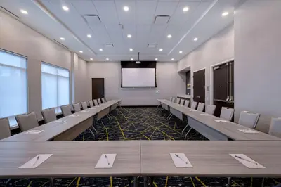 a conference room with rows of chairs and a screen at Hampton Inn & Suites Burlington, Ontario, Canada in Burlington