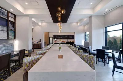 a large dining room with a long table and chairs at Hampton Inn & Suites Burlington, Ontario, Canada in Burlington