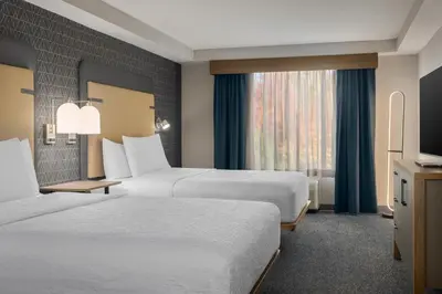 a hotel room with two beds and a window at Homewood Suites by Hilton Toronto-Ajax in Ajax