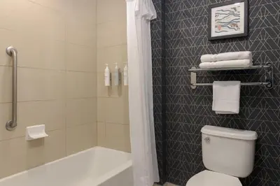 a bathroom with a shower and a toilet and a tub at Homewood Suites by Hilton Toronto-Ajax in Ajax