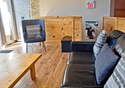 a living room with a couch and a chair at 6BR Blue Mountain Chalet Hot Tub Updated Walk to Village Fun in Blue Mountains