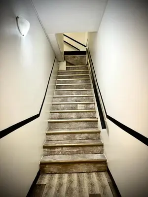 a staircase in a building with wooden floors at Royal Oak Inn in Toronto