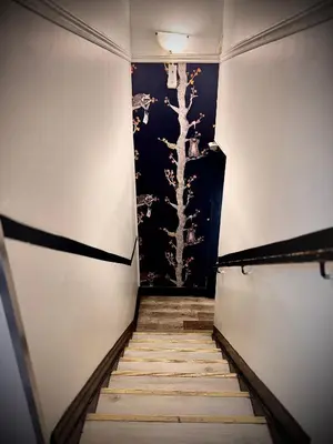 a staircase in a room with a painting on the wall at Royal Oak Inn in Toronto