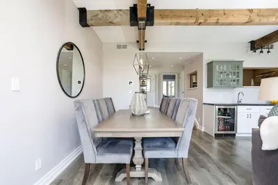 a dining room with a table and chairs and a mirror at Wintergreen Haven 85574 in Blue Mountains