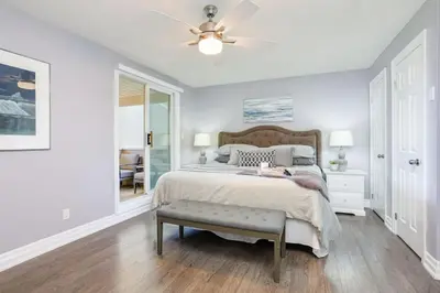 a white bedroom with a bed and a ceiling fan at Wintergreen Haven 85574 in Blue Mountains