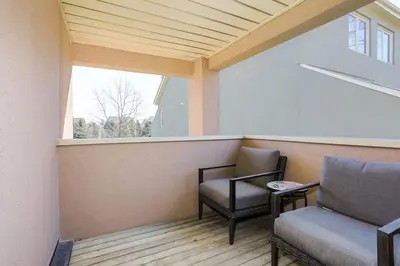 a balcony with two chairs and a window at Wintergreen Haven 85574 in Blue Mountains