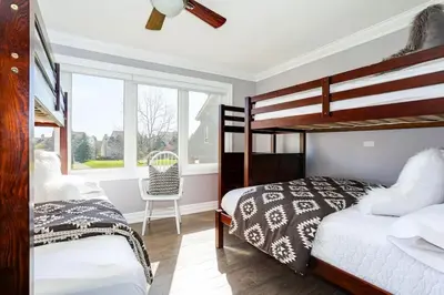 a bedroom with two bunk beds and a window at Wintergreen Haven 85574 in Blue Mountains