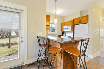 a kitchen with a bar with stools in it at Blue Mountain Getaway Located on Golf Course in Blue Mountains
