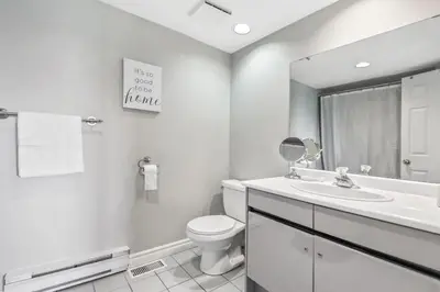 a bathroom with a toilet and a sink and a mirror at All Seasons Sierra Lane Retreat 88371 in Blue Mountains