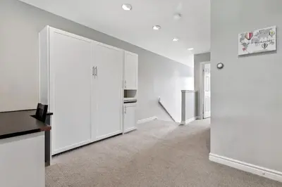 a white kitchen with white cabinets and a stove at All Seasons Sierra Lane Retreat 88371 in Blue Mountains