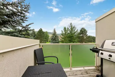 a patio with a table and chairs and a grill at All Seasons Sierra Lane Retreat 88371 in Blue Mountains