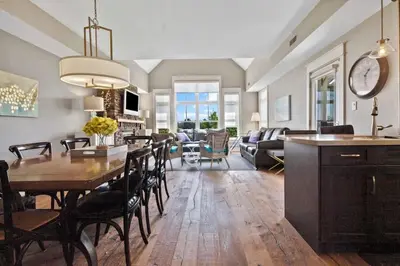 a kitchen and living room with a table and chairs at Rivergrass Townhouse in Blue with Pool Golf Skiing - 219 Rivergrass in Blue Mountains