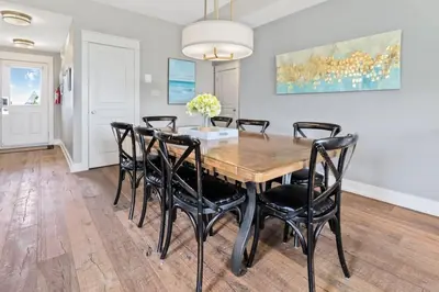 a dining room with a wooden table and black chairs at Rivergrass Townhouse in Blue with Pool Golf Skiing - 219 Rivergrass in Blue Mountains