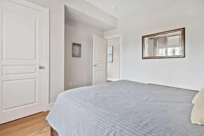 a white bedroom with a bed and a window at Rivergrass Townhouse in Blue with Pool Golf Skiing - 219 Rivergrass in Blue Mountains