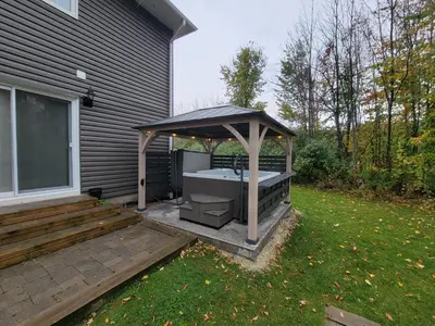 a gazebo with a hot tub on a patio at Scandia Retreat with Hot Tub, Sauna and Fire Pit in Blue Mountains